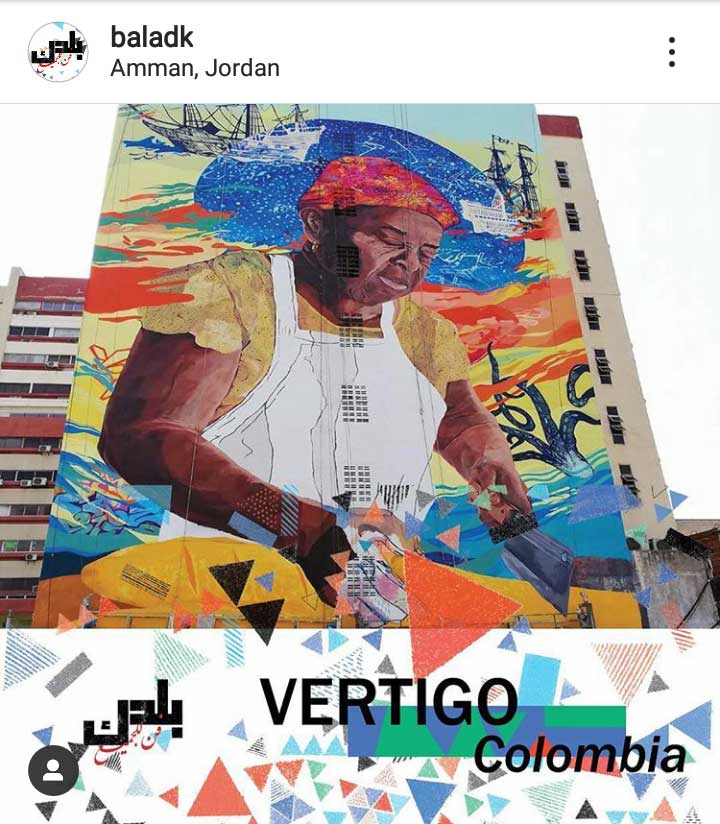 Instagram post promoting the 2019 street art festival. It shows a mural of a person in a kitchen, wearing a head wrap and cutting something. At the bottom of the image is the decorative pattern of triangles and rectangles—used throughout the festival’s visuals—along with the street artist’s name.
